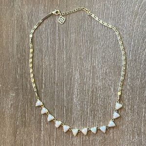 Kendra Scott gold and white iridescent necklace.